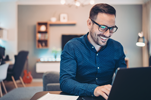 man working on computer smiling